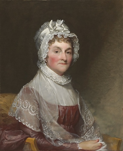 A painted portrait shows Abigail Adams seated and wearing a white bonnet and a sheer white shawl. She is shown from the chest up, looking to the side with a calm expression, against a dark, simple background.