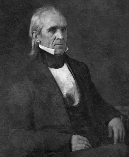 A black-and-white portrait of James K. Polk, the 11th U.S. President, shows him seated and facing the camera with a stern expression. He is wearing a dark coat and vest with a high white collar.