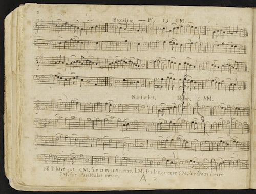 A top-down shot shows a two-page spread from an old, bound book, likely