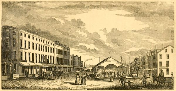 A detailed 19th-century engraving shows a broad cobblestone street lined with multi-story commercial buildings on both sides under a cloudy sky. In the center, a large open-sided market shed is filled with many people gathered beneath its arched roof.