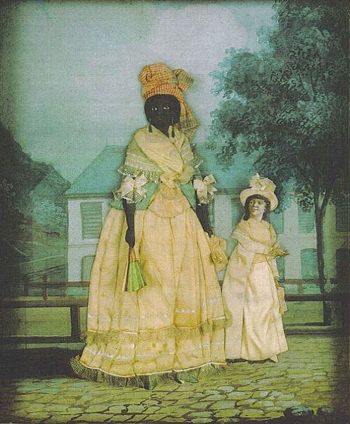 A dark-skinned woman in a yellow gown and headwrap stands next to a small, light-skinned girl in a white dress and bonnet, both posed on a cobbled path before a large white house and trees. The woman holds a green fan, and the background is painted in soft greens and blues, creating a formal portrait setting outdoors.