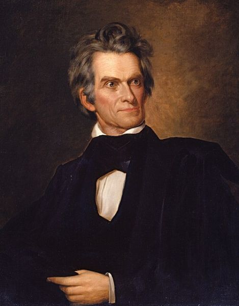 A half-length portrait shows John C. Calhoun, an American statesman, wearing a dark coat and a white cravat, with a piercing gaze directed to the side. The painting highlights his intense expression and prominent facial features against a dark, moody background.