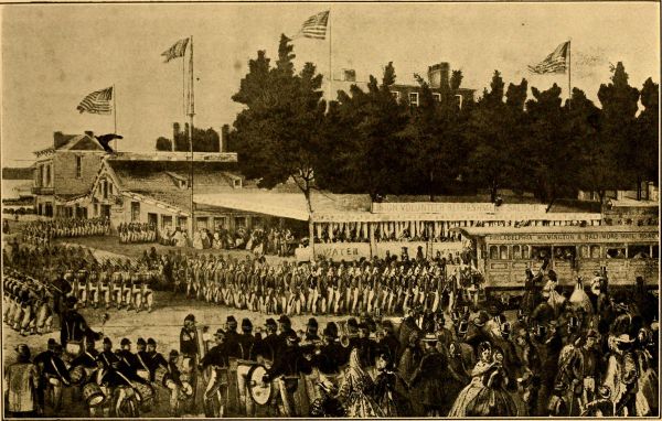 In this sepia-toned illustration, long lines of Union soldiers march in formation through a wide courtyard toward a railroad car and buildings labeled 
