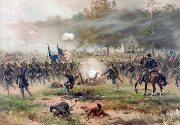 A vibrant color lithograph depicts the Battle of Antietam, showing a line of Union soldiers in blue uniforms charging across a grassy field toward a white farmhouse in the distance. The scene is filled with action, including an explosion in the center of the line, fallen soldiers in the foreground, and officers on horseback leading the advance under large American and regimental flags.