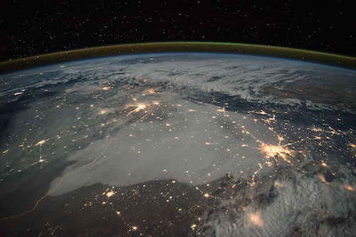 Satellite photo of Northern India at night with clusters of city lights highlighting populated areas.