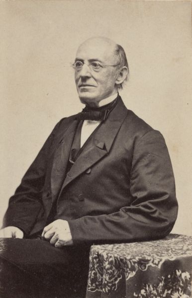 Black-and-white photographic portrait of William Lloyd Garrison, showing him seated and facing the camera, dressed in formal 19th-century clothing.