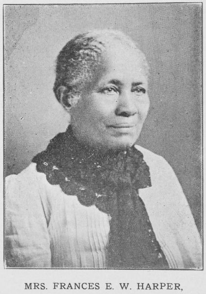 This black and white portrait features Frances E. W. Harper from the chest up, looking toward the right with a faint smile. She is wearing a light-colored, pleated top paired with a dark, textured scarf or lace collar draped around her neck.