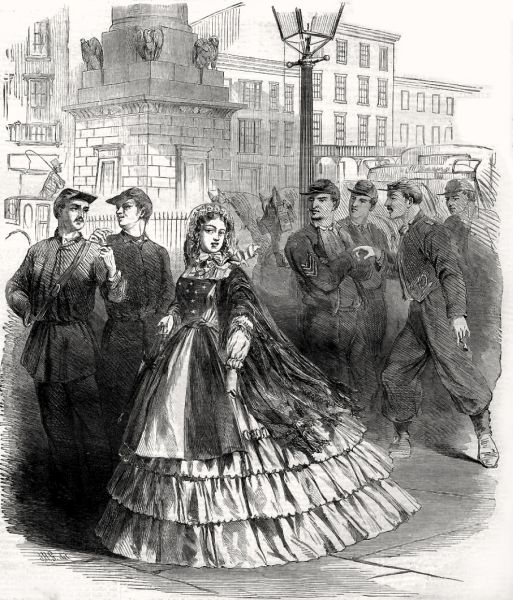 This black-and-white illustration shows a well-dressed woman in a layered, wide-skirted dress standing on a city street, surrounded by several Union soldiers in uniform who appear to be watching or interacting with her. The background features a tall stone monument with eagles and typical urban buildings, suggesting a scene in the mid-1800s.
