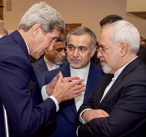 U.S. Secretary of State John Kerry speaks with Iranian officials during diplomatic negotiations.