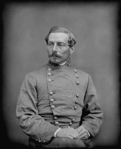 A black and white portrait shows P.G.T. Beauregard with a mustache, dressed in a Confederate general's uniform. He is seated and looking off to the left, wearing a double-breasted gray coat with ornate sleeve embroidery and a stand-up collar.
